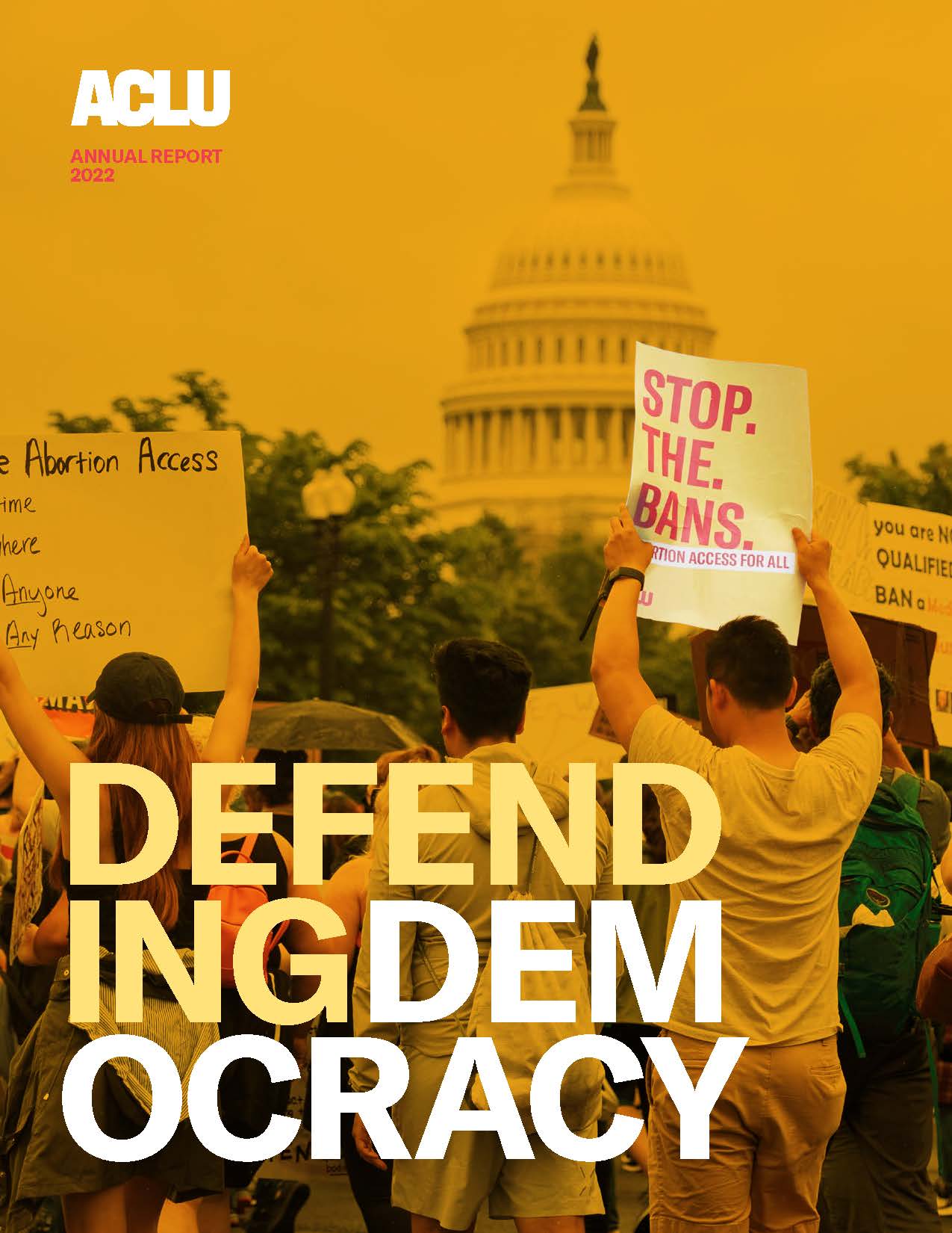Annual report cover showing the U.S. Capitol building in the background and demonstrators hold signs reading "STOP. THE. BANS. Abortion access for all," as well as the TITLE words DEFENDING DEMOCRACY in the foreground.