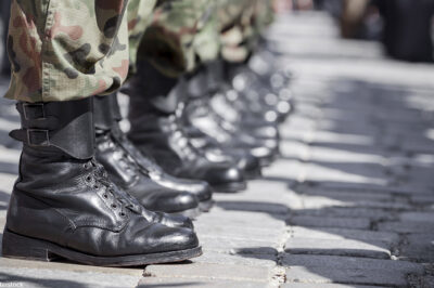 A row of boots belonging to military soldiers.