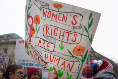 Someone holding a sign that says Women's Rights Are Human Rights.